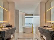 Dual Vanity Area and Bathtub in Suite 