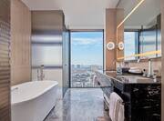 Premium Suite Bathroom with Dual Vanity Area and Bathtub