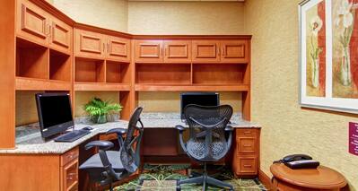 Business Center With Wood Cabinets, Two Computer Workstations, and Ergonomic Chair