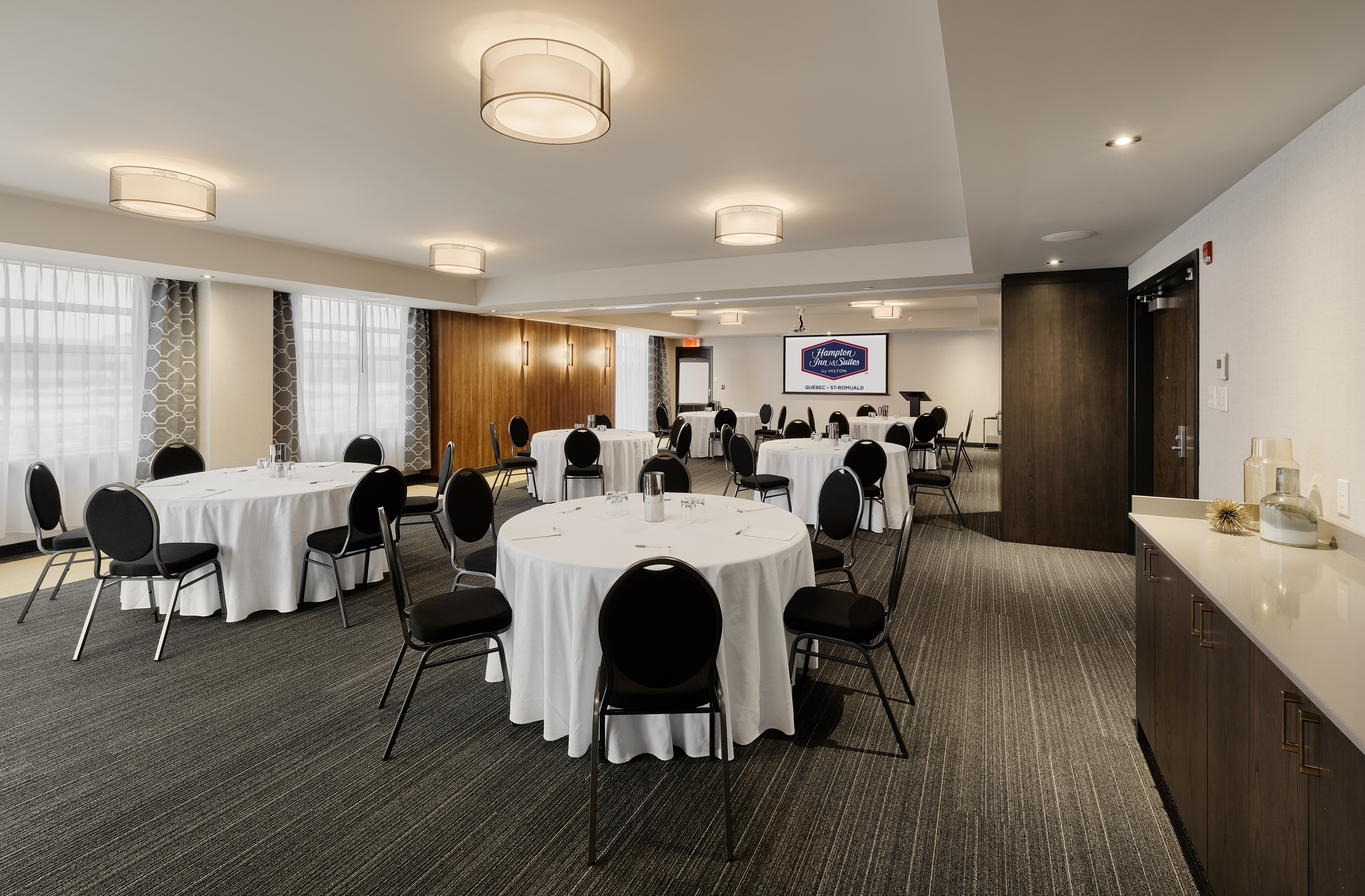Ballroom with Round Tables, Chairs and Wall Mounted HDTV