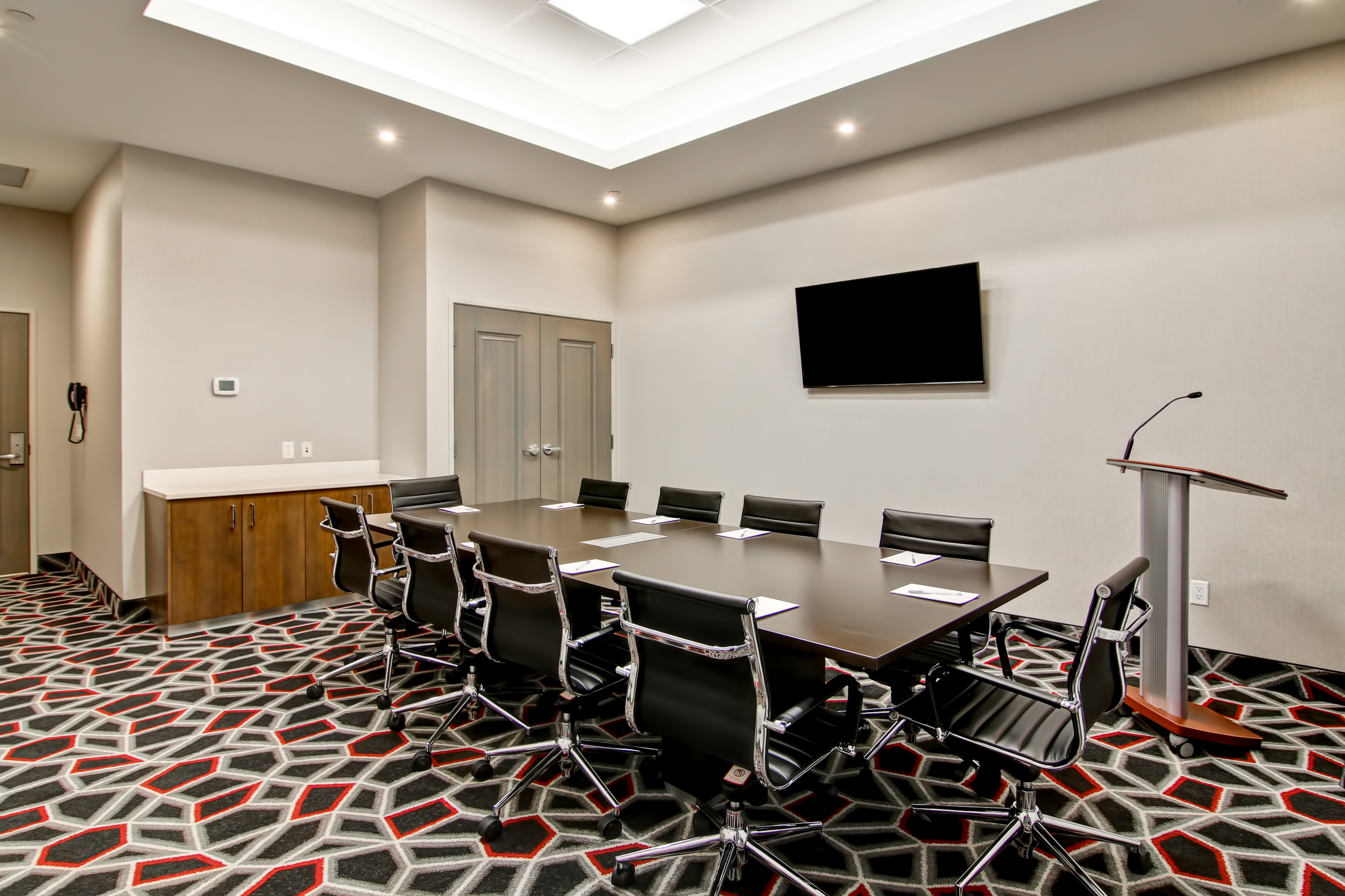 Meeting Room with Meeting Table, Office Chairs, Talker Desk and Wall Mounted HDTV