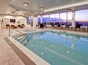 Indoor Swimming Pool and Hot Tub with Deck Chairs