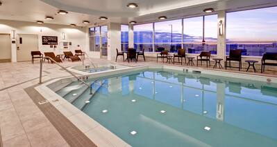 Indoor Swimming Pool and Hot Tub with Deck Chairs