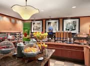 Breakfast Buffet Area with Fruit Bowls and Coffee Dispensers
