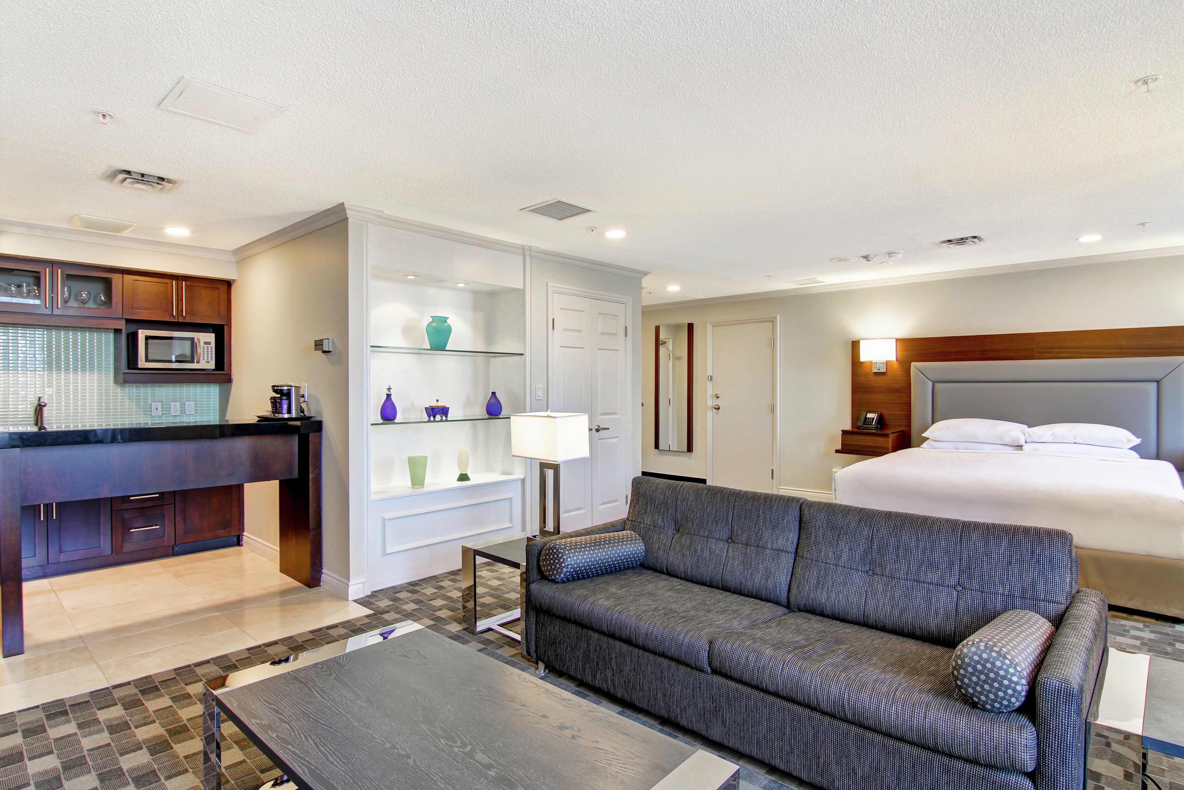 Suite Kitchen, Lounge Area, and King Bed
