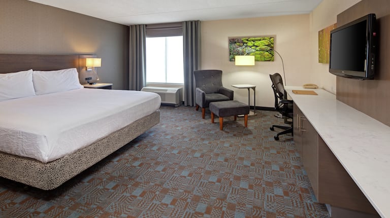 Guest Room with King Bed, Work Desk, and Lounge Chair with Ottoman