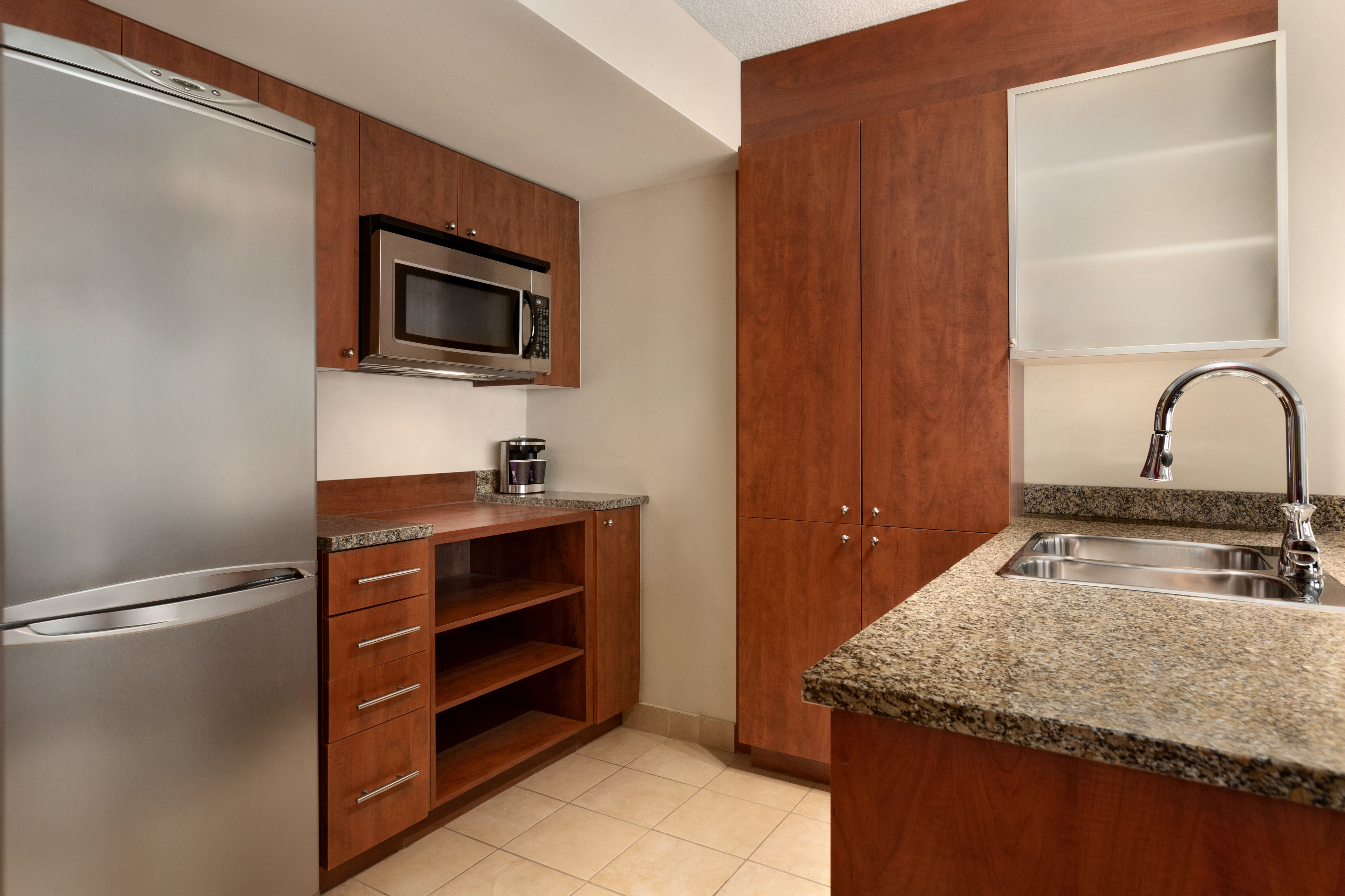 Kitchen Area with Stainless Appliances in a Hotel Suite