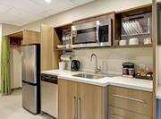 Suite Kitchen with Refrigerator, Dishwasher, Sink, and Microwave