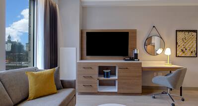 guest room lounge area with work desk and television