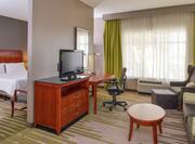 Guestroom Suite with Room Technology, Lounge Area, and Work Desk