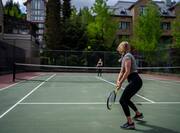 people playing tennis outdoors