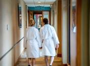 couple in robes walking to spa