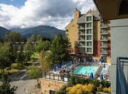 Hotel Exterior and Outdoor Pool with Mountains in Background