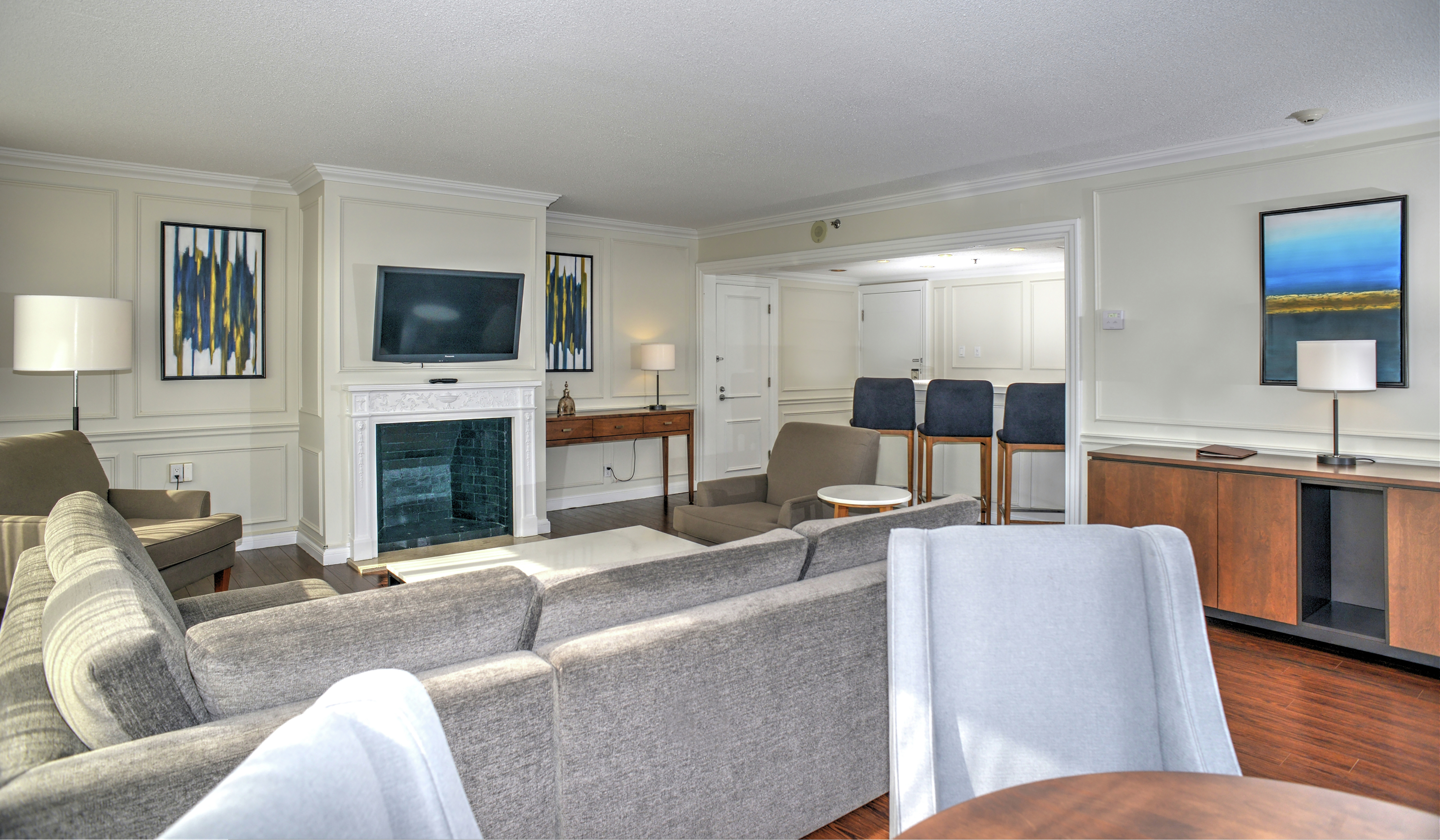 Prime Minister Suite Living Area with Sofa, Fireplace, and Wall-Mounted TV