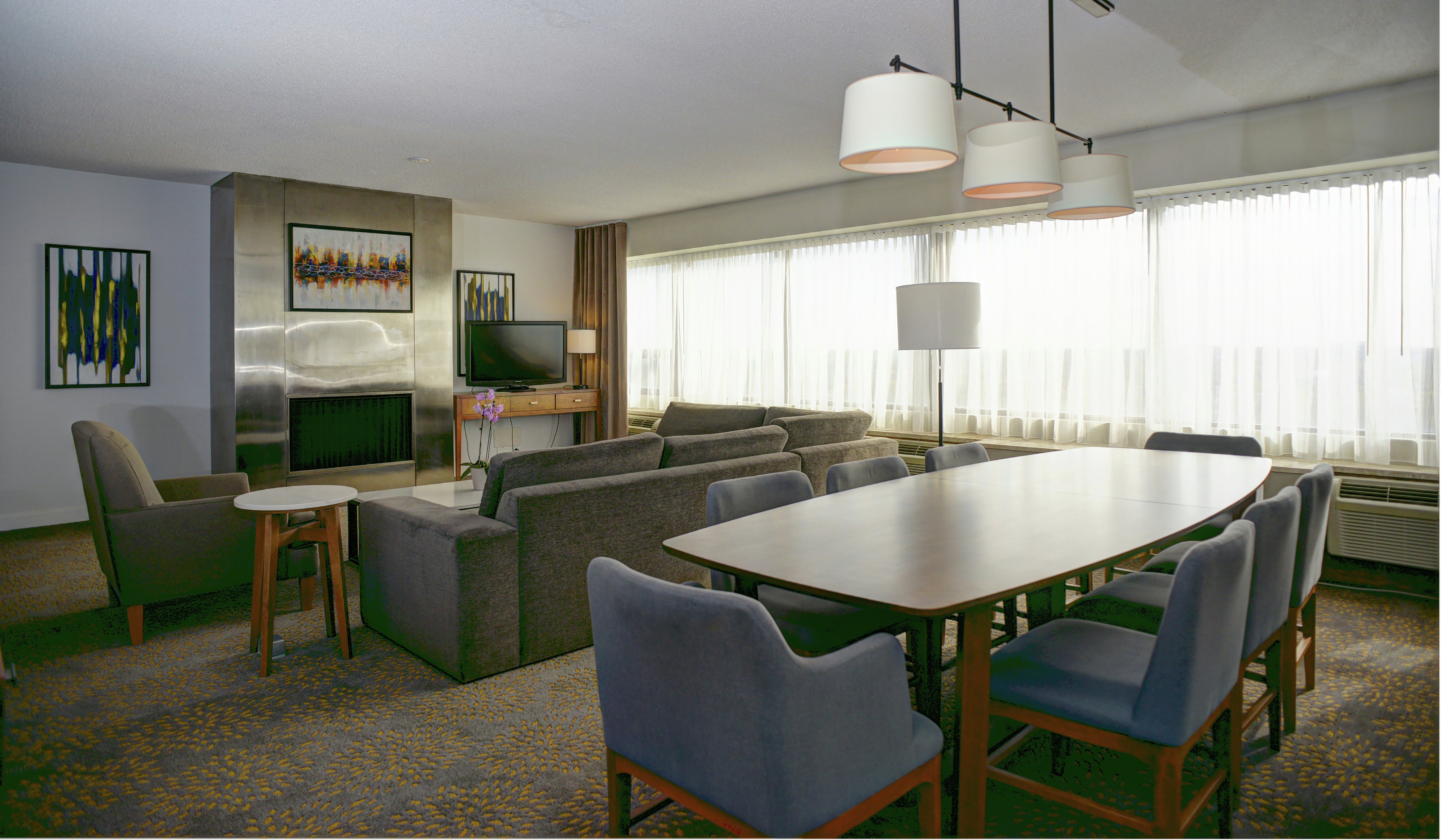 Executive Suite Dining Area with Living Area in Background