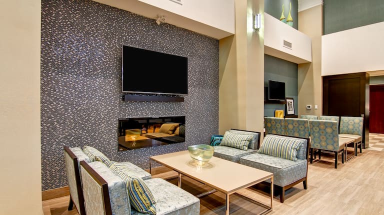 Lobby Seating Area with a Variety of Seating and Setups with Coffee Tables and Wall-mounted TVs