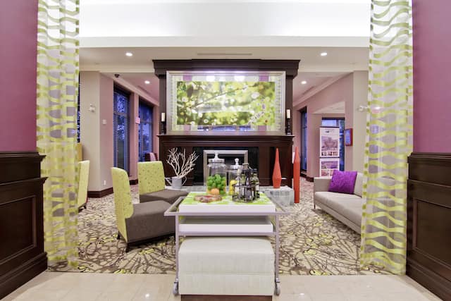 Beverage Station, Long Drapes, and Mixed Lounge Seating by Fireplace in Lobby 