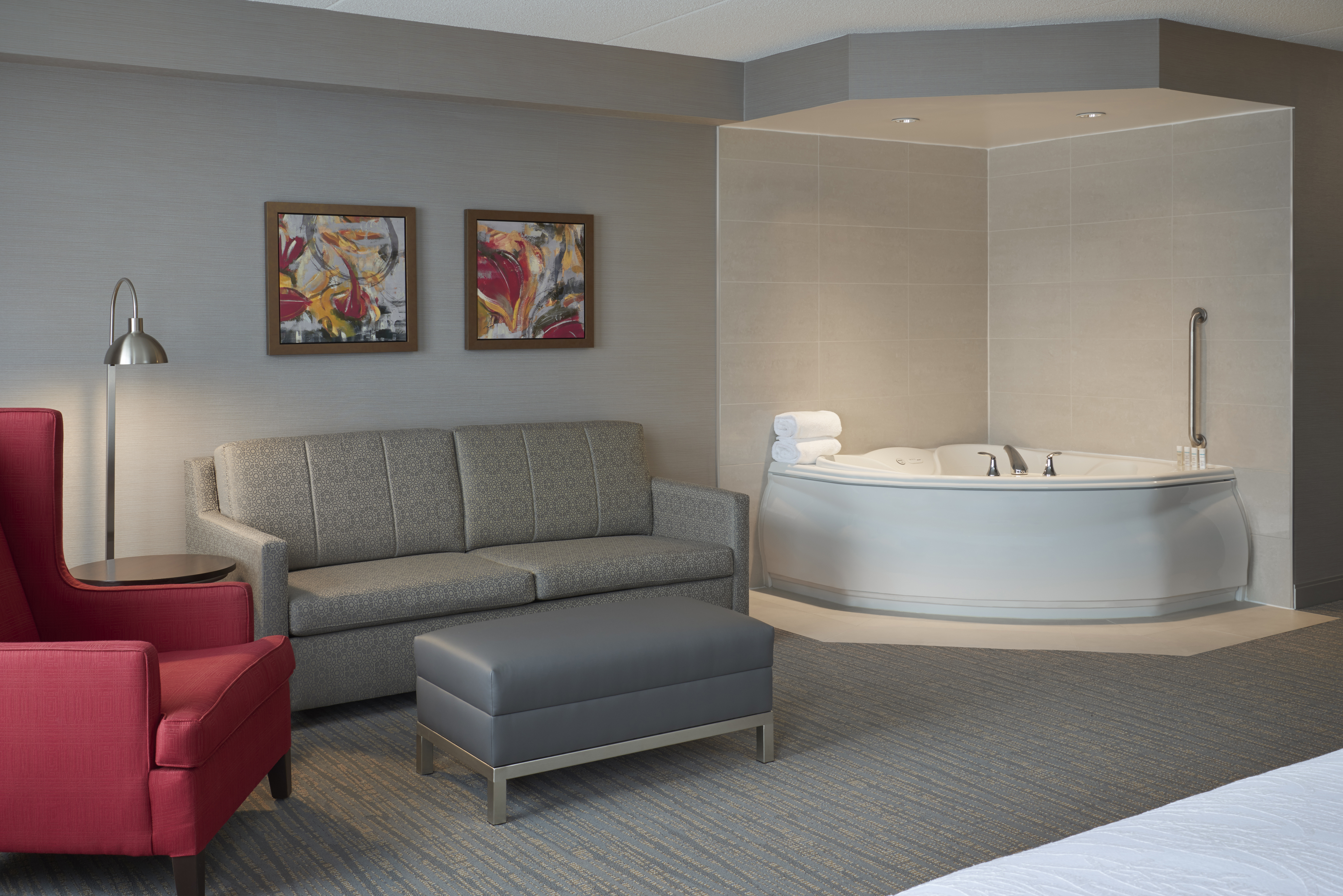 Guest Suite Lounge Area with Sofa, Armchair, Footrest and Whirlpool Tub