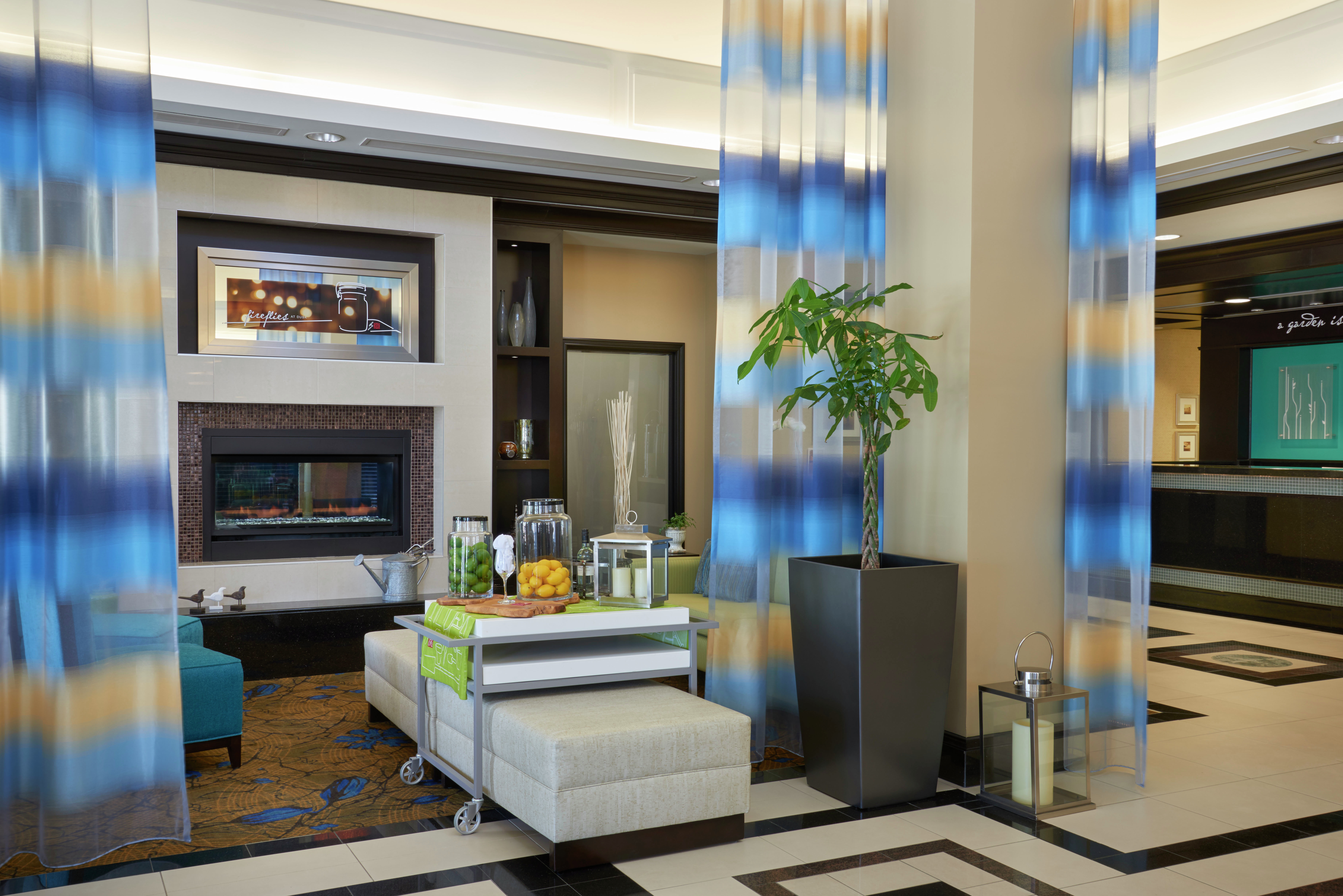 Beverage Station, Lounge Seating, Long Drapes, Fireplace in Lobby With View of Front Desk