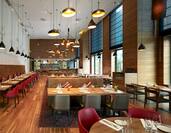Modern restaurant with red leather seats and hanging ceiling lights