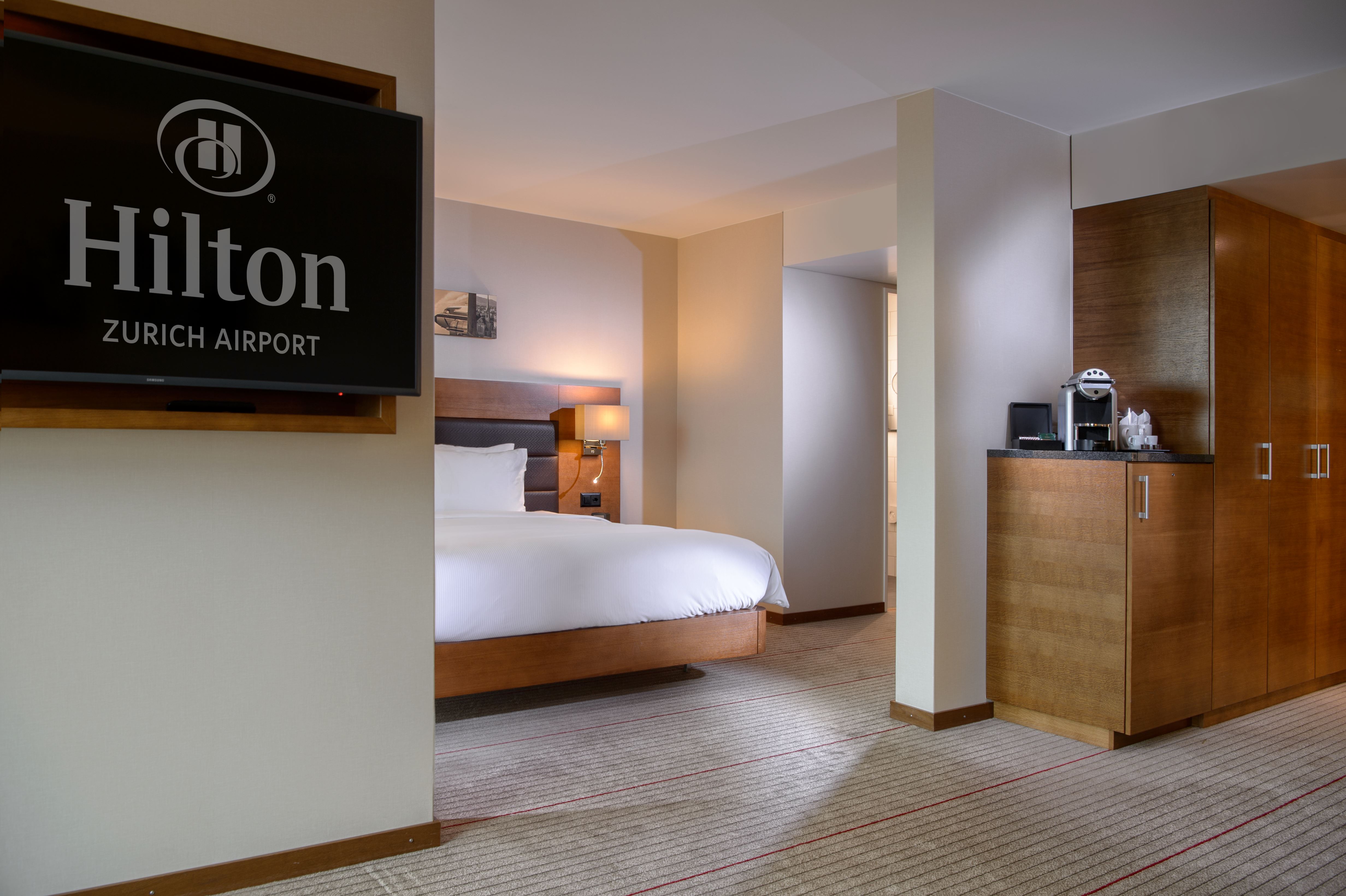 Angle View of Queen Junior Suite with Hilton Logo