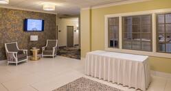 Ballroom Pre-Function Area with Table, Armchairs and Wall Mounted HDTV